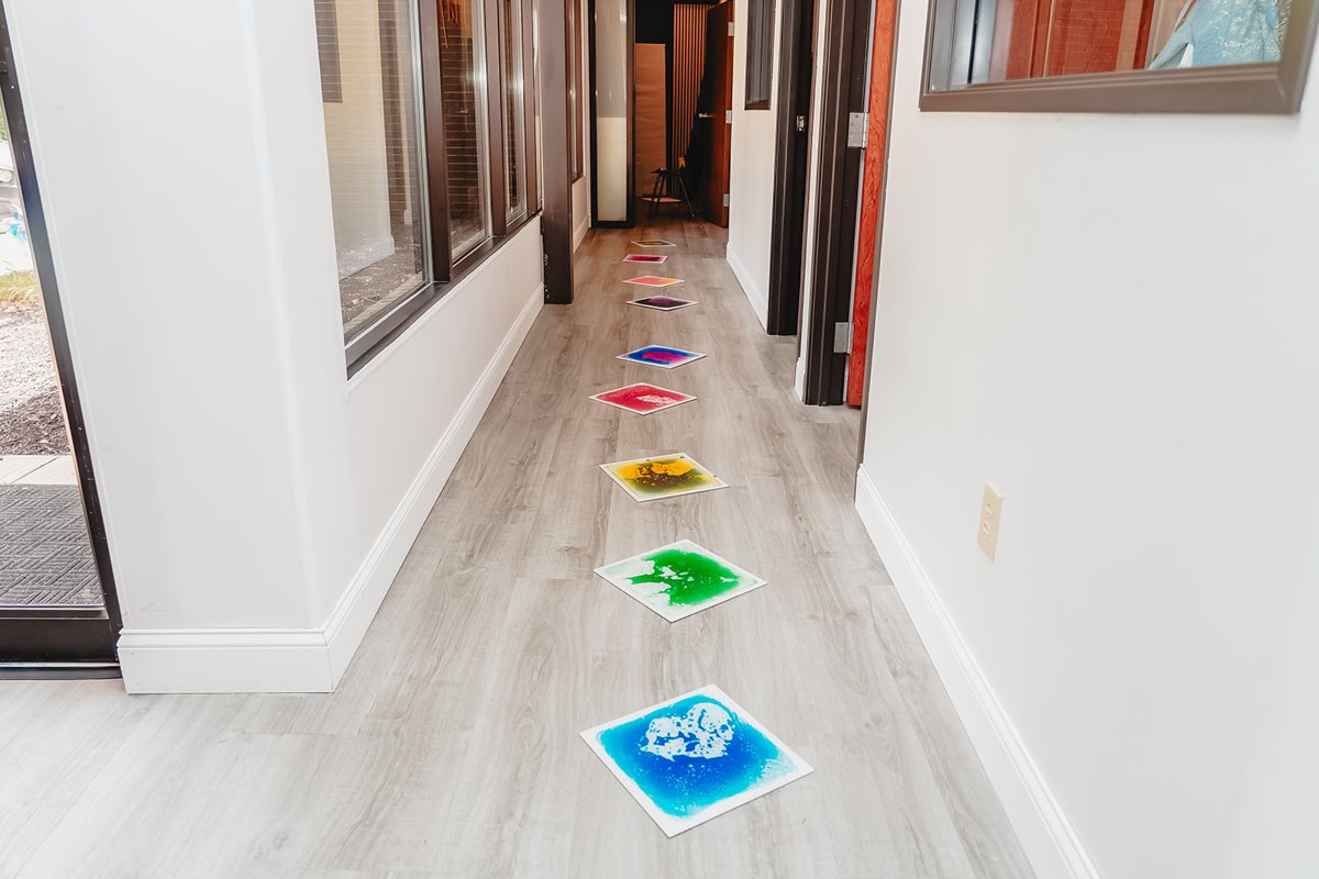 Sensory-lit hallway leading to the private therapy rooms at Prana Play in Carmel, Indiana